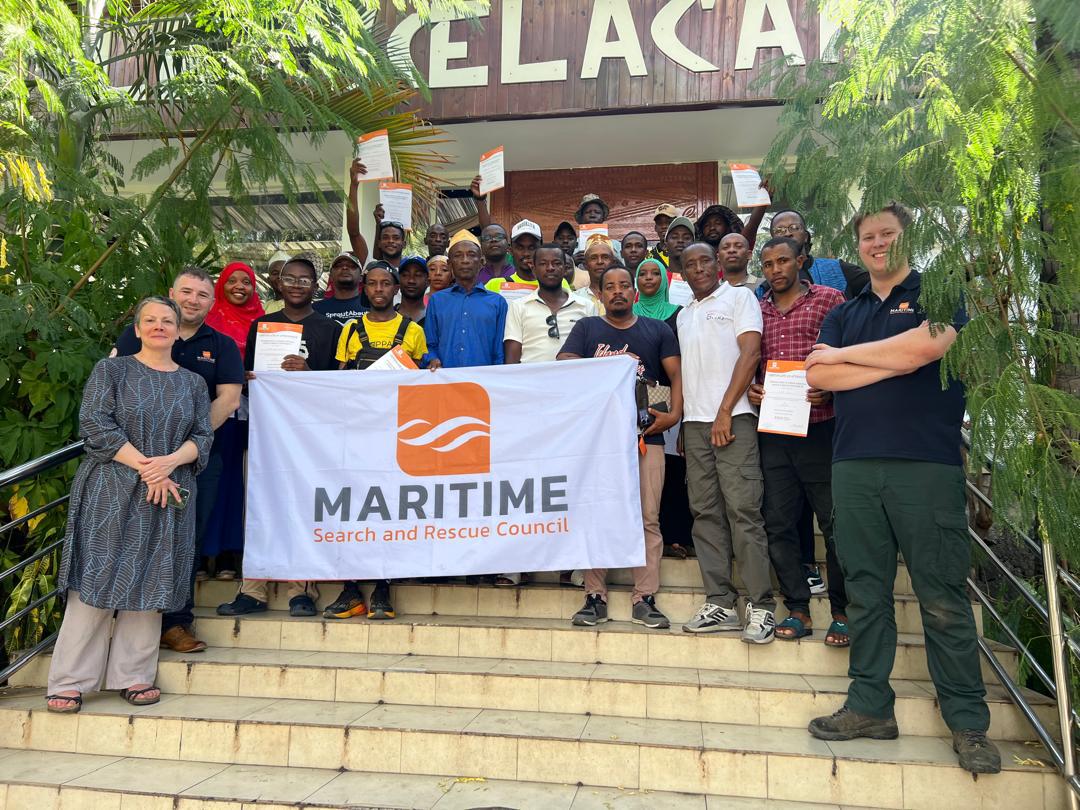 Maritime Search and Rescue Council team and course participants holding the MSARC banner after a training session